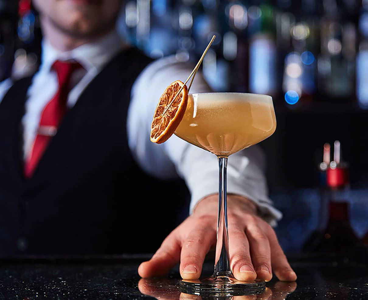 Elegant cocktail served in chic London bar.
