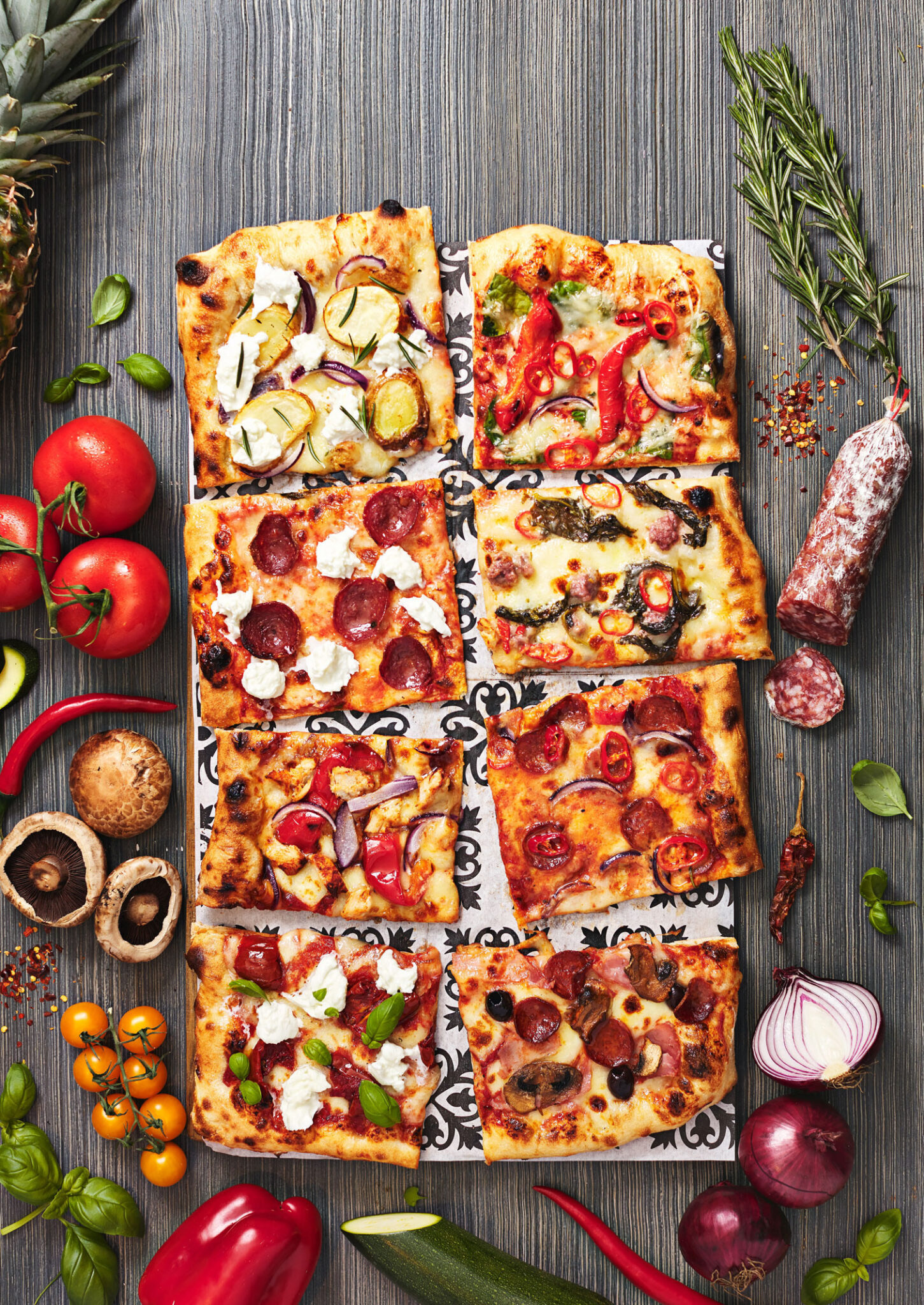 Assorted toppings on Firezzas rectangular pizza with fresh ingredients.