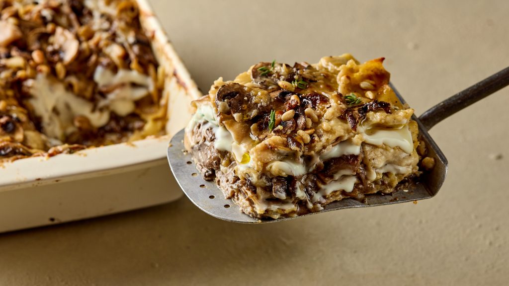 Cheesy beef lasagne portion on a serving spatula.