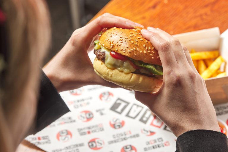 Savoury cheeseburger with crispy fries - Fast food indulgence.