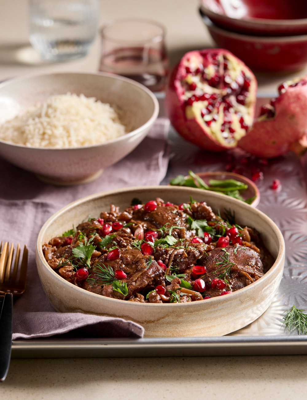 Warm and inviting Persian chicken stew with fluffy rice and pomegranate seeds.